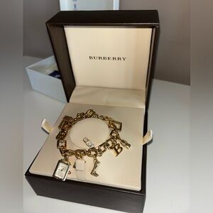 Burberry NWOT never worn Gold Charm Bracelet with Iconic Charms. Stunning!